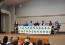 Urbanism on the Eastside Panel Hints at Suburban Sea Change The six panelists sit at a table with the Urbanist U logo on it and Ryna Packer is off to the side moderating.