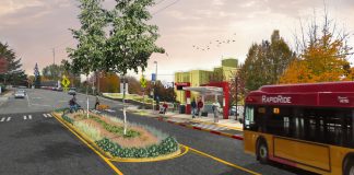 King County Council Unsnags RapidRide I Line After Property Disputes A rendering of a RapidRide bus arriving at a newly rebuilt bus stop with bus shelter and RapidRide pylon, with a median in the street adding trees and pedestrian safety. Riders wait under the shelter and two people use the cross walk, one walking a bike.