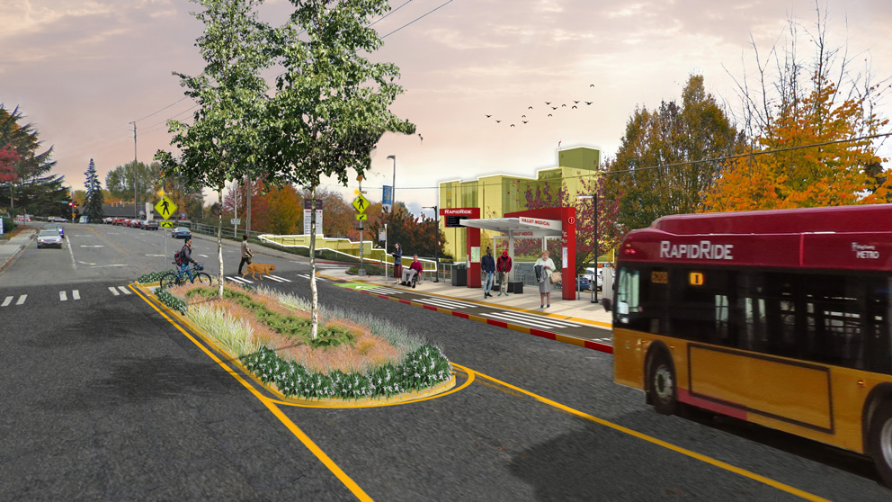 A rendering of a RapidRide bus arriving at a newly rebuilt bus stop with bus shelter and RapidRide pylon, with a median in the street adding trees and pedestrian safety. Riders wait under the shelter and two people use the cross walk, one walking a bike.