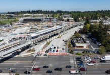 Federal Way Link Stations Not Seeing a Housing Boom An aerial image shows an elevated light rail station next to a big staging area and a busy collector road.