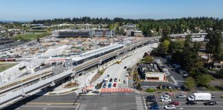 Federal Way Link Stations Not Seeing a Housing Boom An aerial image shows an elevated light rail station next to a big staging area and a busy collector road.