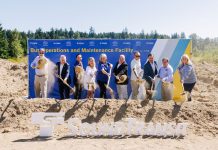Sound Transit Breaks Ground on Stride Electric Bus Base in Bothell Action shot catches the ceremonial first shovelful of dirt from a row of officials in mid-air.