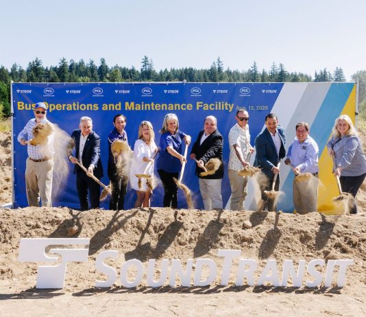 Sound Transit Breaks Ground on Stride Electric Bus Base in Bothell Action shot catches the ceremonial first shovelful of dirt from a row of officials in mid-air.
