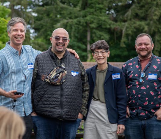Progressives Well-Positioned for Burien Council Takeover The four candidate stand in a line smiling with trees in the background.