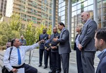 Harrell Pledges Police Contract by Year End – Adding Election Wrinkle Officials including Bob Kettle and Debora Juarez and SPD top brass stand on the steps of Seattle's US Courthouse with a reporter outstretching an arm holding a mic to interview them