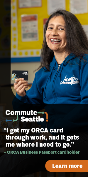 A woman smiles holding an Orca transit card. The caption reads: I get my Orca card through work, and it gets me where I need to go -Orca Business Passport cardholder.