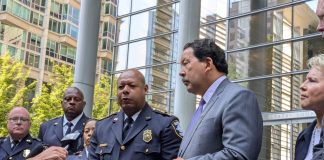 Officials stand on the steps of Seattle's US Courthouse after the consent decree hearing.