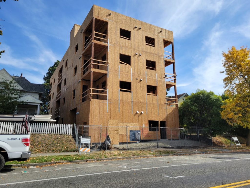 Wood frame construction for a four-story building, counting the basement garage.