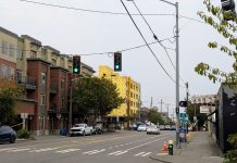 Urbanists Push to Amend Seattle Growth Plan Ahead of Final Vote Looking up Phinney Avenue with a five-story apartment building on the corner and another under construction just north.