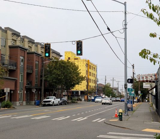 Urbanists Push to Amend Seattle Growth Plan Ahead of Final Vote Looking up Phinney Avenue with a five-story apartment building on the corner and another under construction just north.
