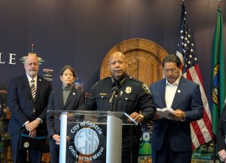 Harrell and SPOG Rush Police Contract, Hamstringing Civilian Responders, Accountability Agencies Barnes standard at the lectern with the City seal behind.
