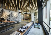 Two Weeks Until The Urbanist’s Winter Holiday Party A reading nook in The Collective includes a mural of a mountain range