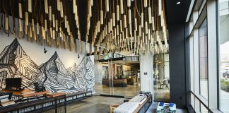 Two Weeks Until The Urbanist’s Winter Holiday Party A reading nook in The Collective includes a mural of a mountain range