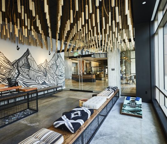 Two Weeks Until The Urbanist’s Winter Holiday Party A reading nook in The Collective includes a mural of a mountain range