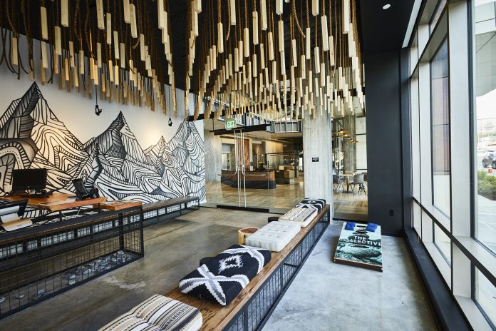 A reading nook in The Collective includes a mural of a mountain range