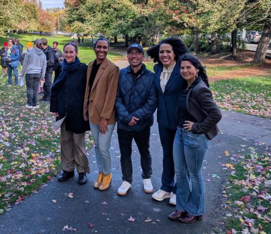 Looking Back on The Urbanist’s 2025 The five candidates stand shoulder to shoulder in Columbia Park, which is lined with trees in full autumn colors.