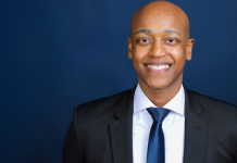 After Victory, Zahilay Announces County Executive Transition Team Girmay Zahilay, a Black millennial man wearing a suit, standing in front of a blue background