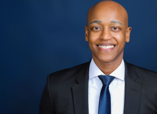 After Victory, Zahilay Announces County Executive Transition Team Girmay Zahilay, a Black millennial man wearing a suit, standing in front of a blue background