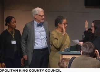King County Council Appoints Top Zahilay Aide to Vacant Council Seat Lewis holds up her right hand to do the oath of office with a King County judge. Lewi's family is by her side.