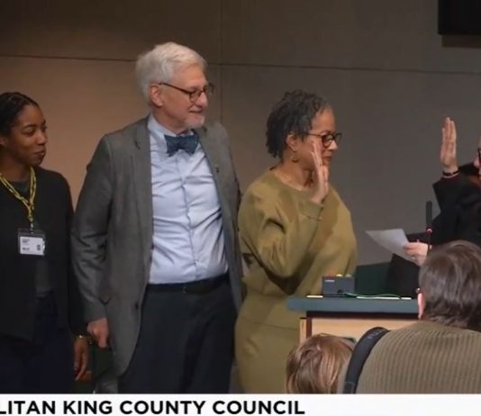 King County Council Appoints Top Zahilay Aide to Vacant Council Seat Lewis holds up her right hand to do the oath of office with a King County judge. Lewi's family is by her side.
