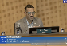 Three Councilmembers Dissent as City Approves Controversial Seattle Police Guild Contract Councilmember Rob Saka sits on the council dais in a tan sportscoat.