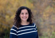 Climate Advocate Nilu Jenks Announces D5 Seattle Council Campaign Jenks smiles and has dark wavy hair and wears a striped sweater.