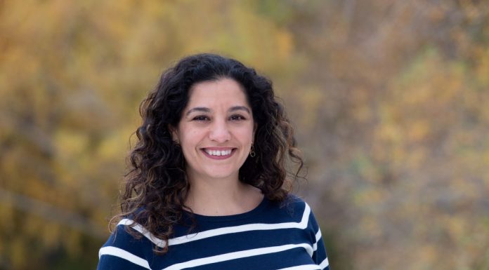 Climate Advocate Nilu Jenks Announces D5 Seattle Council Campaign Jenks smiles and has dark wavy hair and wears a striped sweater.
