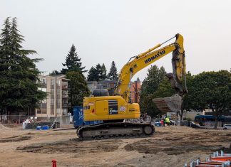 Seattle Poised to Remove SEPA Review Hurdle for Most Housing Projects A Komatsu backhoe at a large midrise construction site on Stone Way in Fremont.