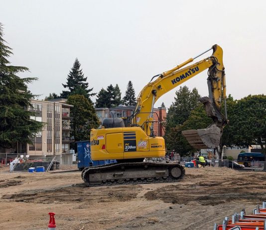 Seattle Poised to Remove SEPA Review Hurdle for Most Housing Projects A Komatsu backhoe at a large midrise construction site on Stone Way in Fremont.