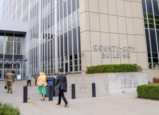 ICE’s Tacoma Detention Center Targeted in New Lawsuit Alleging Abuses A stream of people in formal clothes walk into a modern concrete and plate class courthouse building