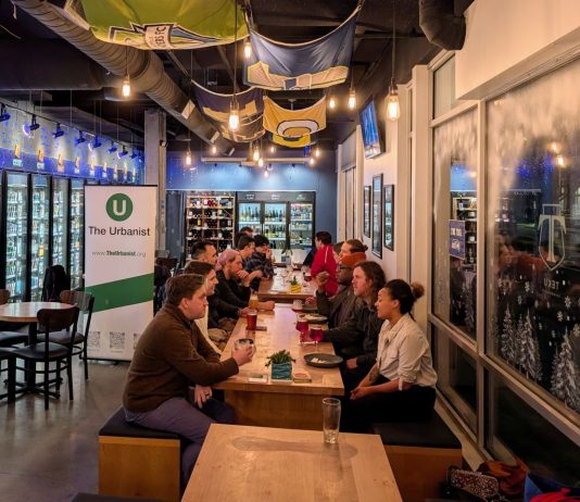 Join Us for February Urbanist Socials and Waterways Presentation March 3rd About 20 urbanists sit around a long table in the tavern.