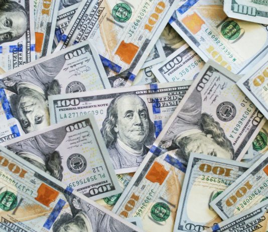 Op-Ed: Washington Legislature, Don’t Reverse the Estate Tax A big pile of $100 bills with Benjamin Franklin's face peering out.