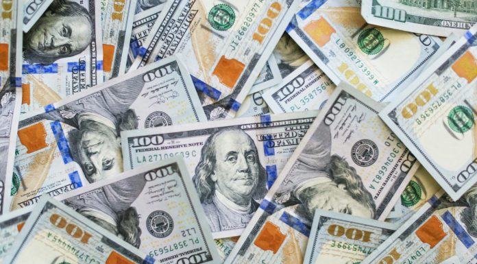 Op-Ed: Washington Legislature, Don’t Reverse the Estate Tax A big pile of $100 bills with Benjamin Franklin's face peering out.